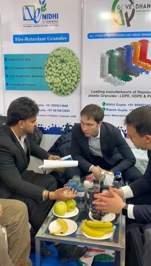 Nikhil Singh discussing polymer materials at a trade booth